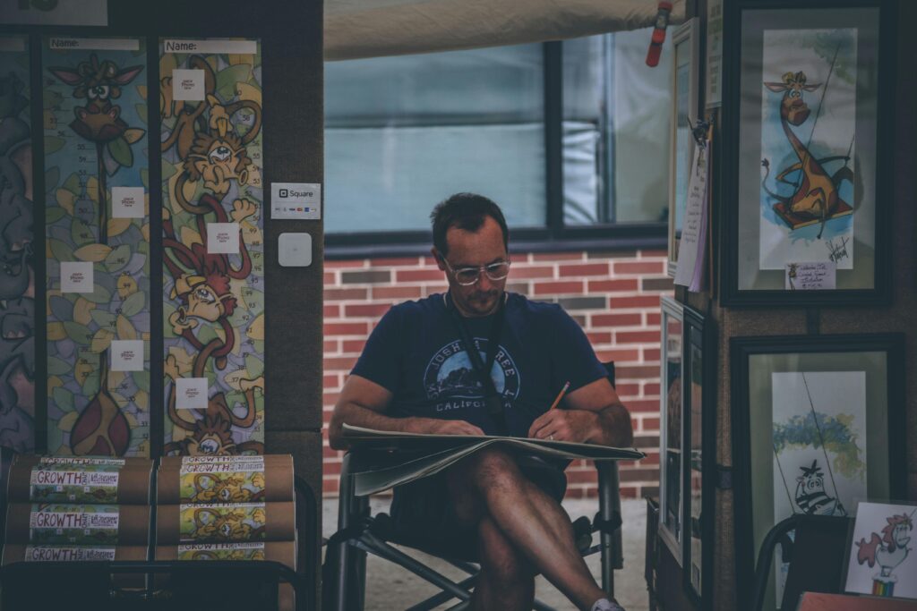 man drawing at a pop-up gallery