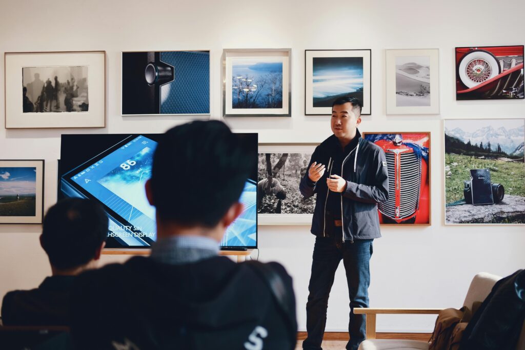 man explaining artworks on the wall