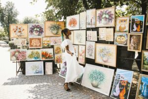 the power of pop-up galleries - woman watching paintings outdoors